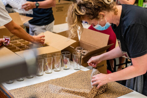 woman gift wraps in leopard paper