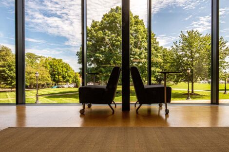 Two chairs outside of a window looking into the Quad, in Skillman Library