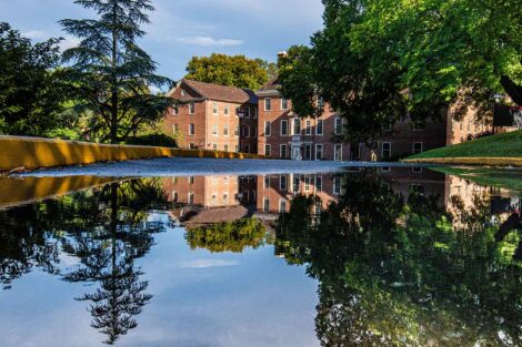 Kirby House with its reflection in a puddle