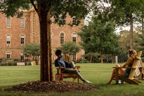 A photo of students talking on the Quad in masks
