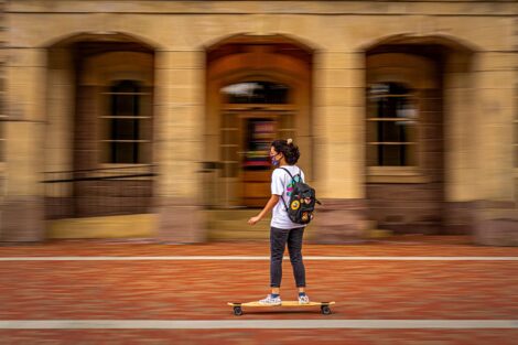 A student skateboards past Pardee