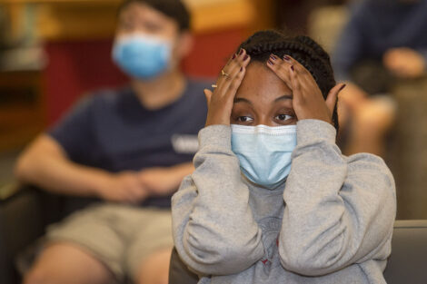 a student reacts to the first 2020 presidential debate during a watch party