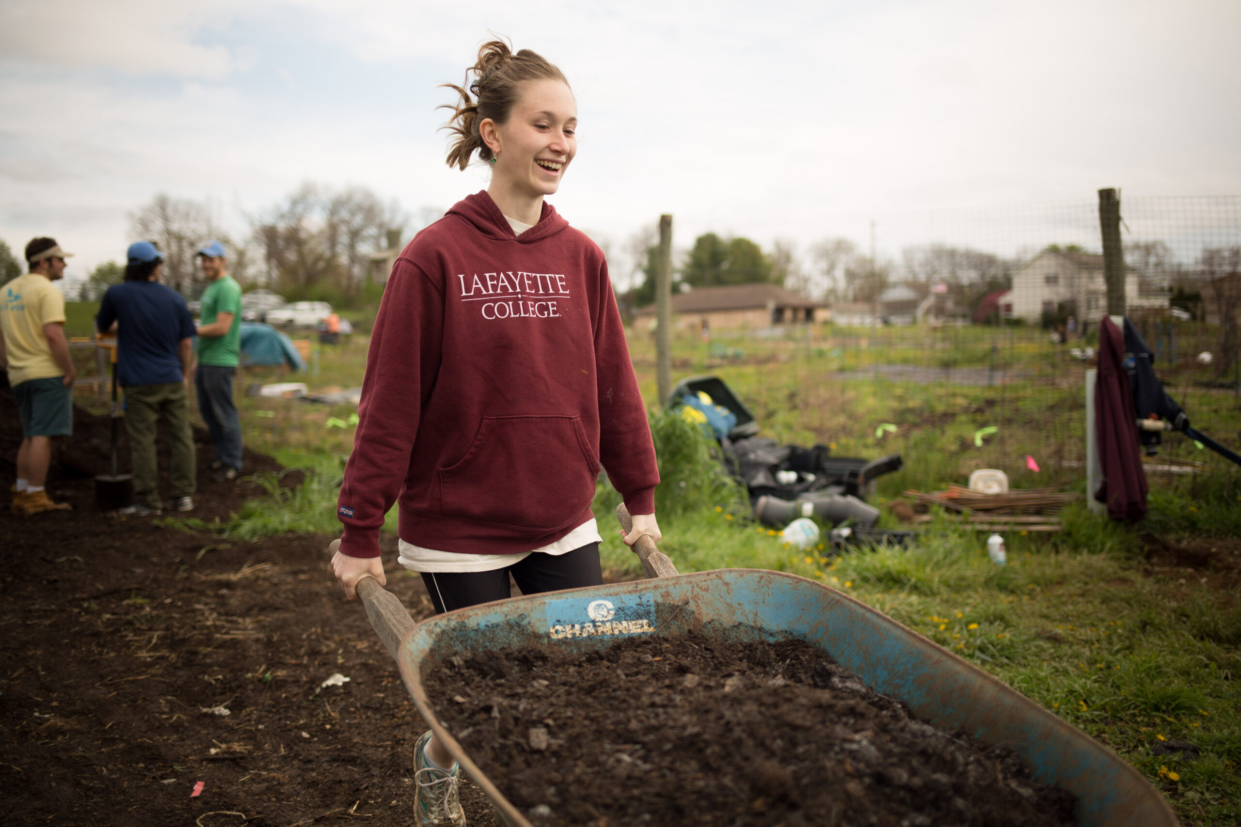 Miranda Wilcha pushing a wheelbarrow at LaFarm