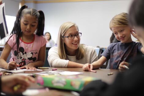 Student engages with elementary student during an activity