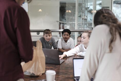 Elementary student points at computer screen