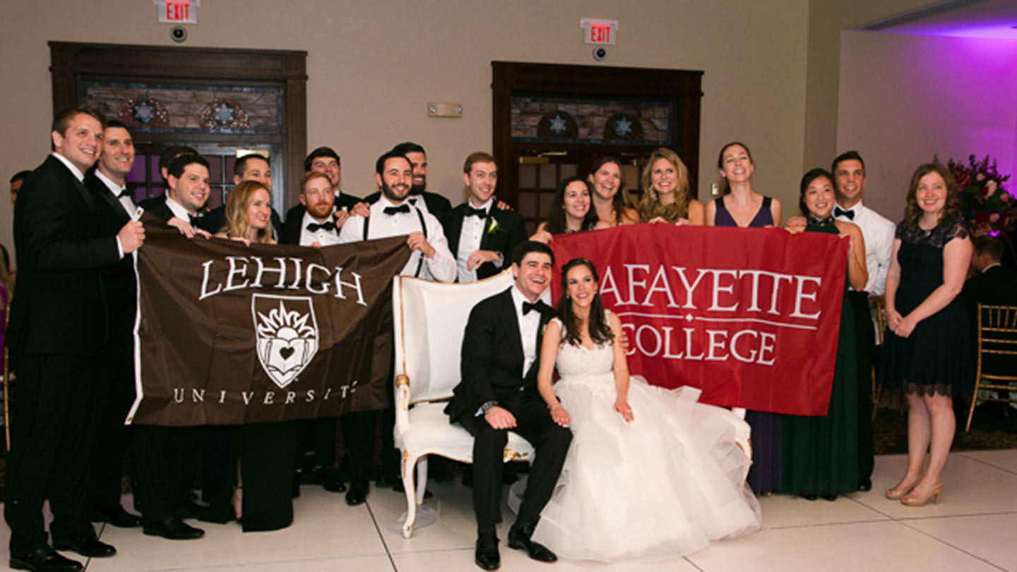 Guests at a wedding with Lafayette and Lehigh banners