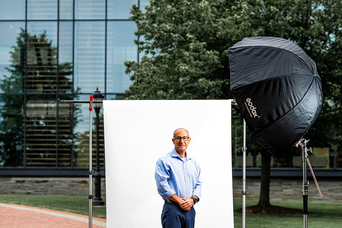Dr. Jeff Goldstein in front of a white screen, set up in front of Skillman library