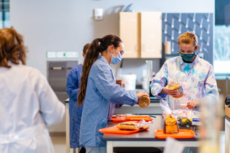 biology students wearing masks in Rockwell pop popcorn as part of a lab