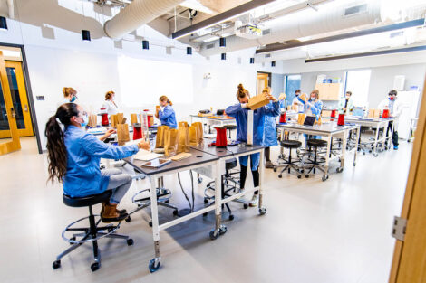 biology students wearing masks in Rockwell pop popcorn as part of a lab
