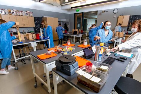 biology students wearing masks in Rockwell pop popcorn as part of a lab