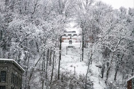 Snow covered Hill that leads from College Hill to Downtown Eston. A statue can be seen toward the top of the hill.