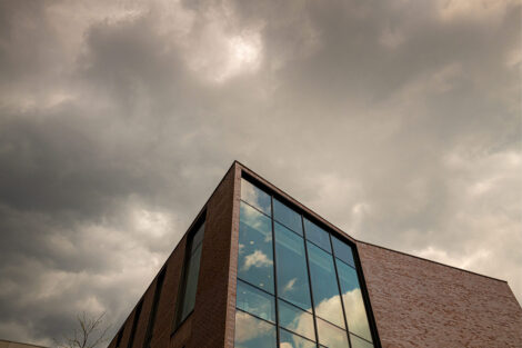Grey storm clouds and Rockwell Integrated Sciences Center