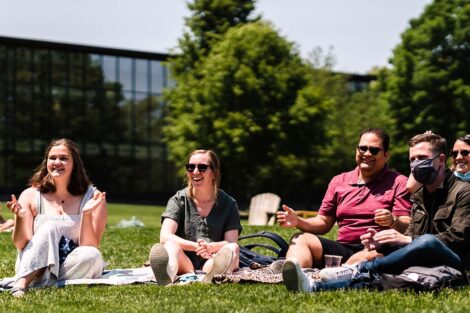 students sit on the Quad and listen to the bands