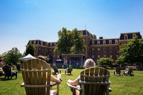 students sit on the Quad and listen to the bands