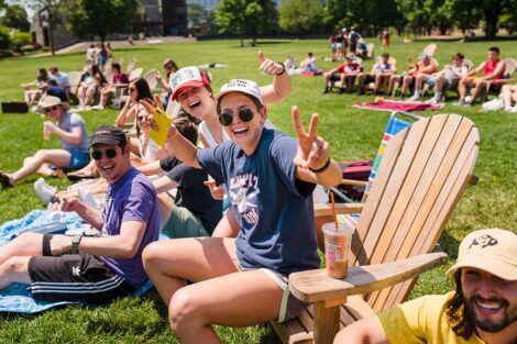 students sit on the Quad and listen to the bands