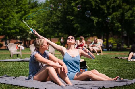 students play with bubbles on the Quad