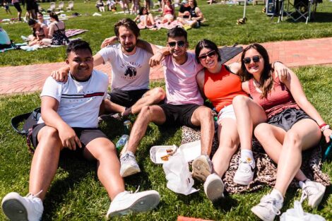 students sit on the Quad and listen to the bands