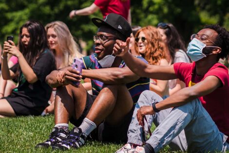 students sit on the Quad and listen to the bands