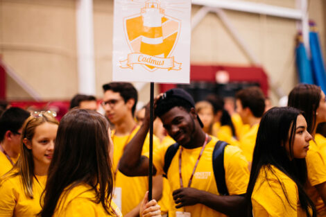 Students in matching yellow tshirts talk