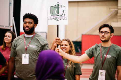 Two students hold a flag.