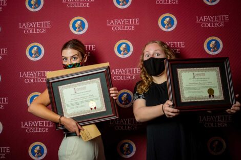 Student representatives of Disabilities Awareness Week holding Aaron O. Hoff Awards and standing in front of Lafayette College backdrop