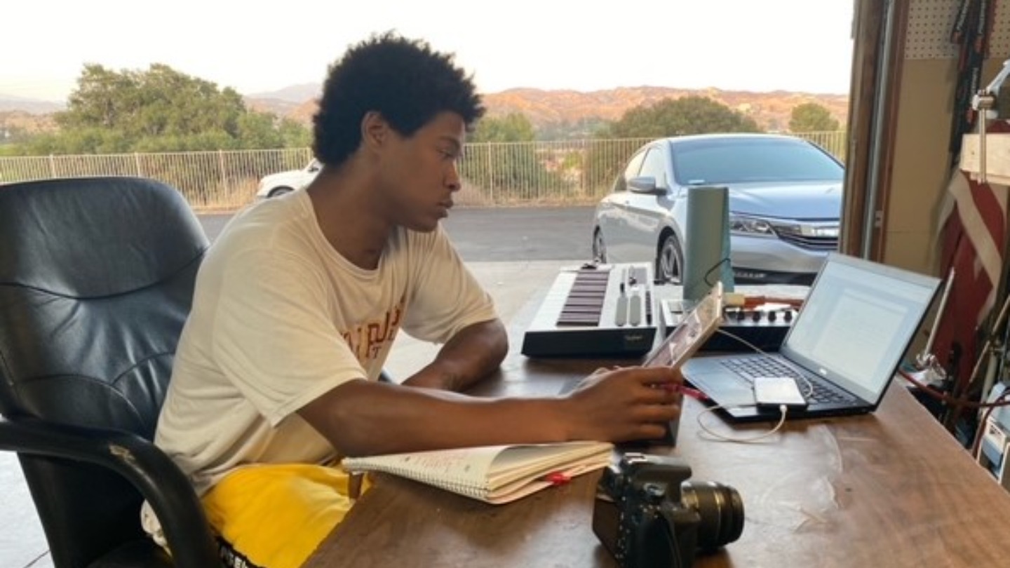 Kaizer studying at home sized and cropped_adobespark