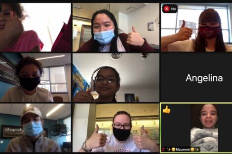 A group of students from literacy all take a moment on Zoom to give a thumbs up