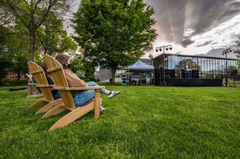 Students sit at Adirondack chairs as Jerry Greenfield speaks.