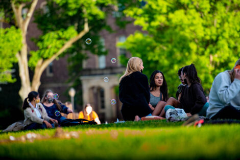 Students sit on the Quad before Jerry Greenfield speaks.