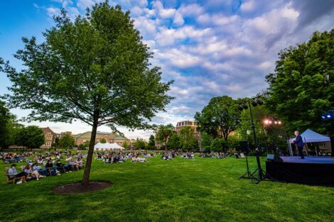 Students sit on blankets on the Quad as Jerry Greenfield speaks.
