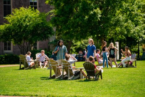 Many students in groups on the Quad.