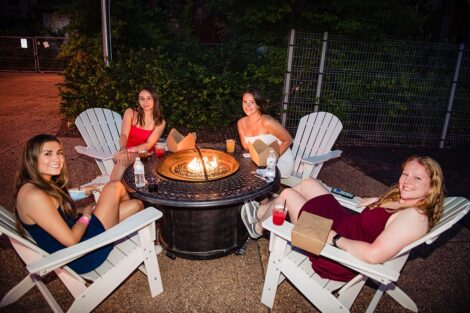 Students sit around a fire pit at Last Night celebration.