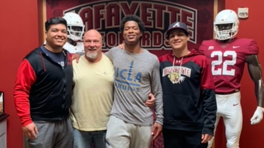 Matt Bayly and Kaizer Butler and Butler's brothers smile together