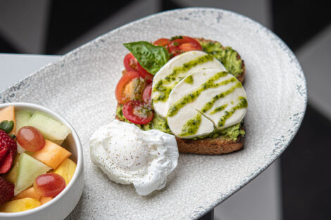 Trolley Stop's avocado toast with fruit and poached egg