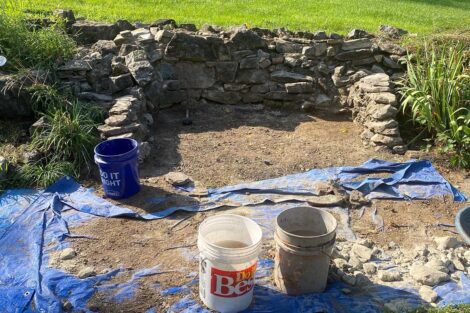 The fire pit has weed removed and the side walls rebuilt. The base is read to begin