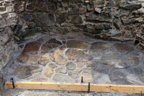 A 2x4 board ensures the floor is level