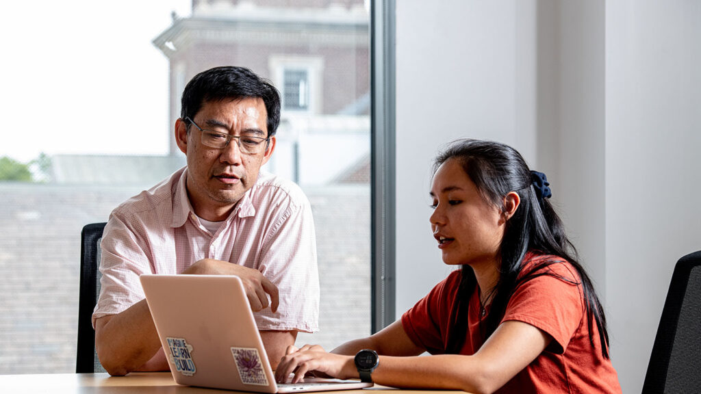 Eric Ho and Erica Chen with laptop
