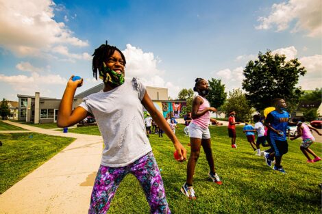A community member from the Boys and Girls Club throws a ball.
