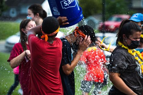 A Lafayette students gets a bucket of water dumped on their head.