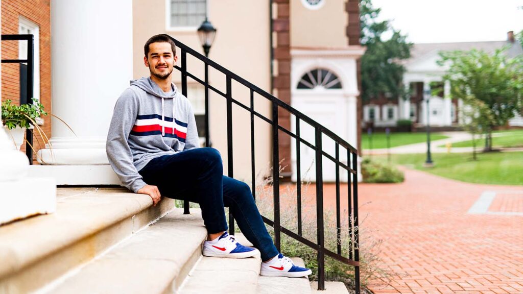 Antonie sits on the steps at South College