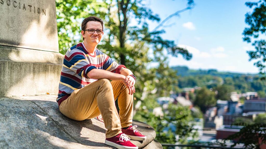 Charles sits on the foundation of a statue that overlooks the city of Easton