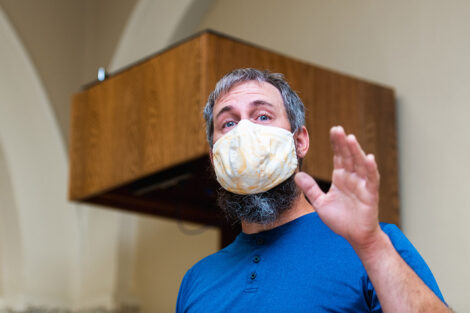 A person in a mask inside of Van Wickle Hall