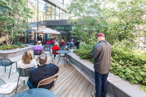 Families sit outside at Goodwyn Plaza, Rockwell Integrated Science Center.