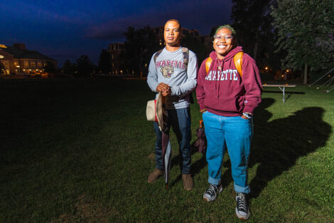 Two students smile on the Quad.
