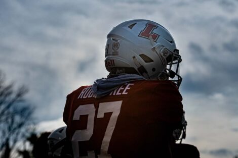 The back of a football player in uniform.