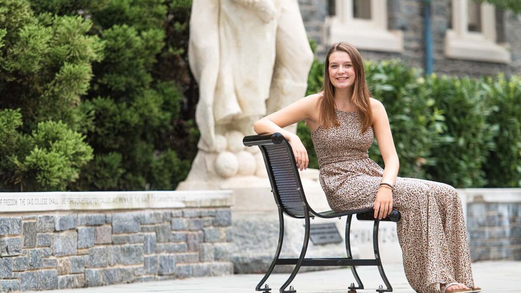 Jillian sits behind Hogg Hall at the base of the Marquis statue
