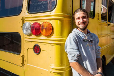 Remy Oktay '23 outside of converted bus.