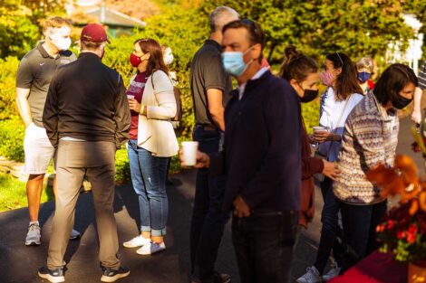 parents in masks mingle outside