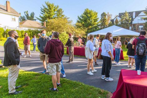 parents in masks mingle outside