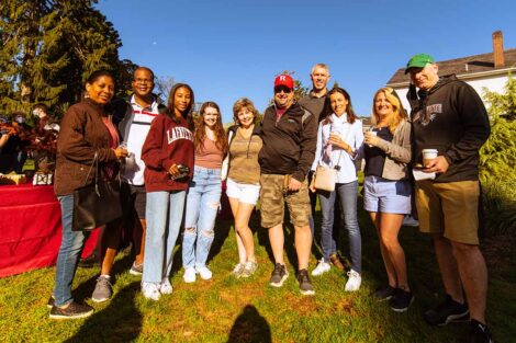 members of three different families smile outside, wearing Lafayette gear